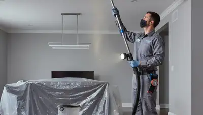 Technician cleaning air ducts for HVAC system in Brooklyn, NY home by Five Star Cooling